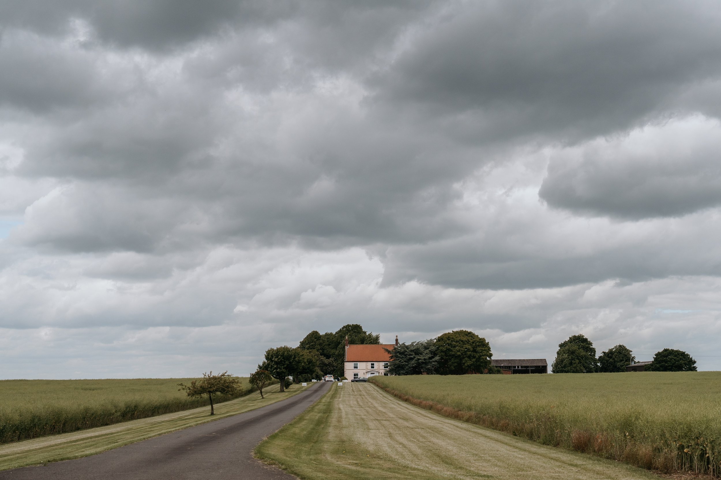 The driveway through the fields to the barns