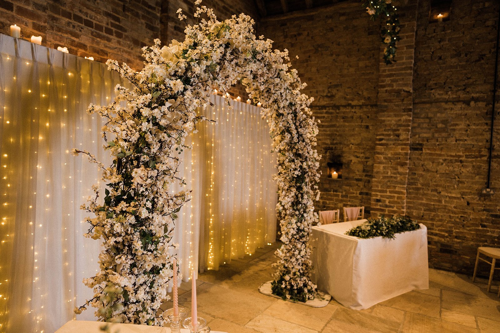 The floral moongate arch and dressed top table