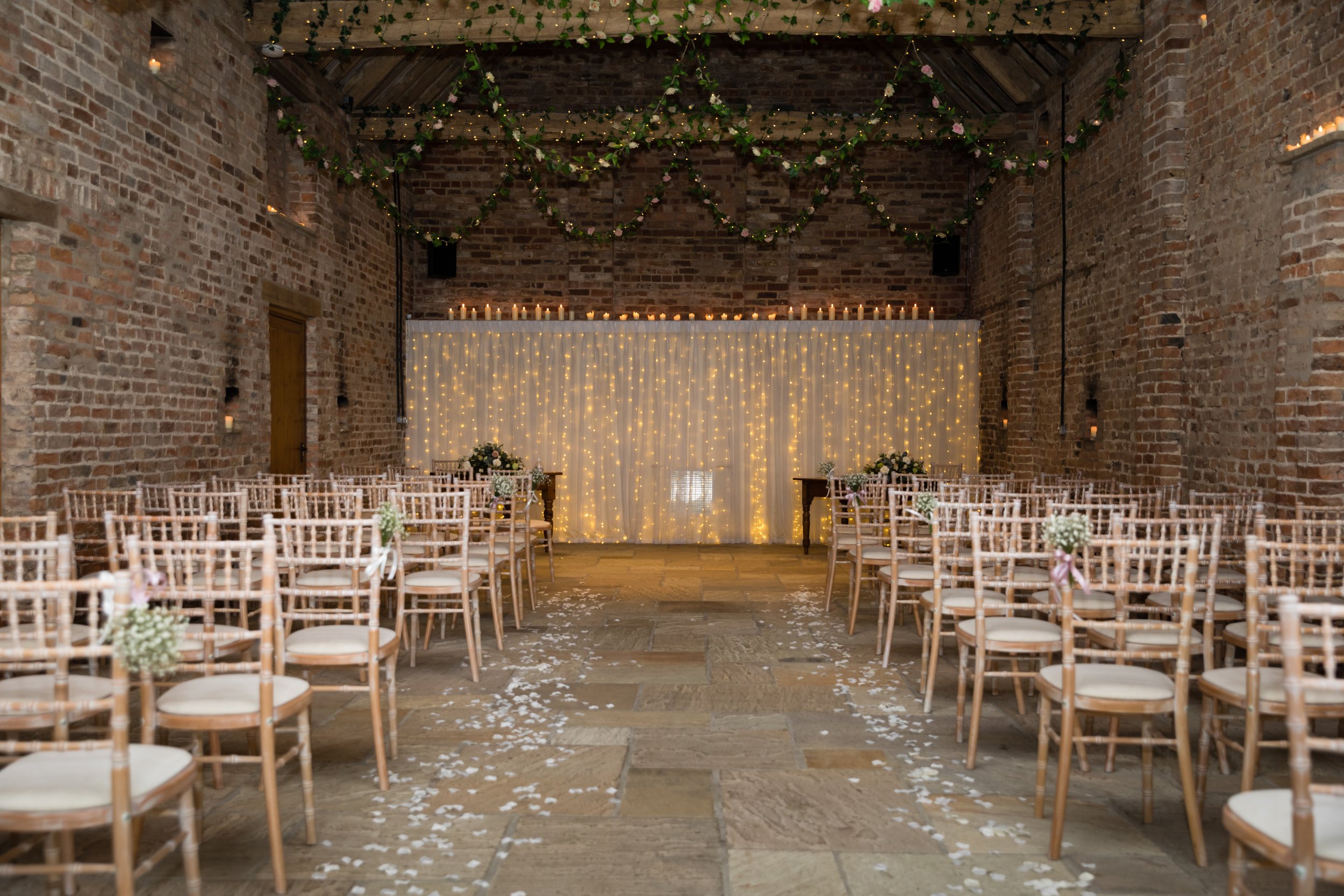Chiavari chairs and a floral aisle in the Ceremony Barn