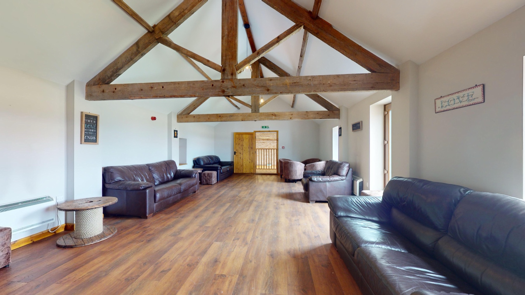 The Granary lounge from the far end, with sofas and exposed beams