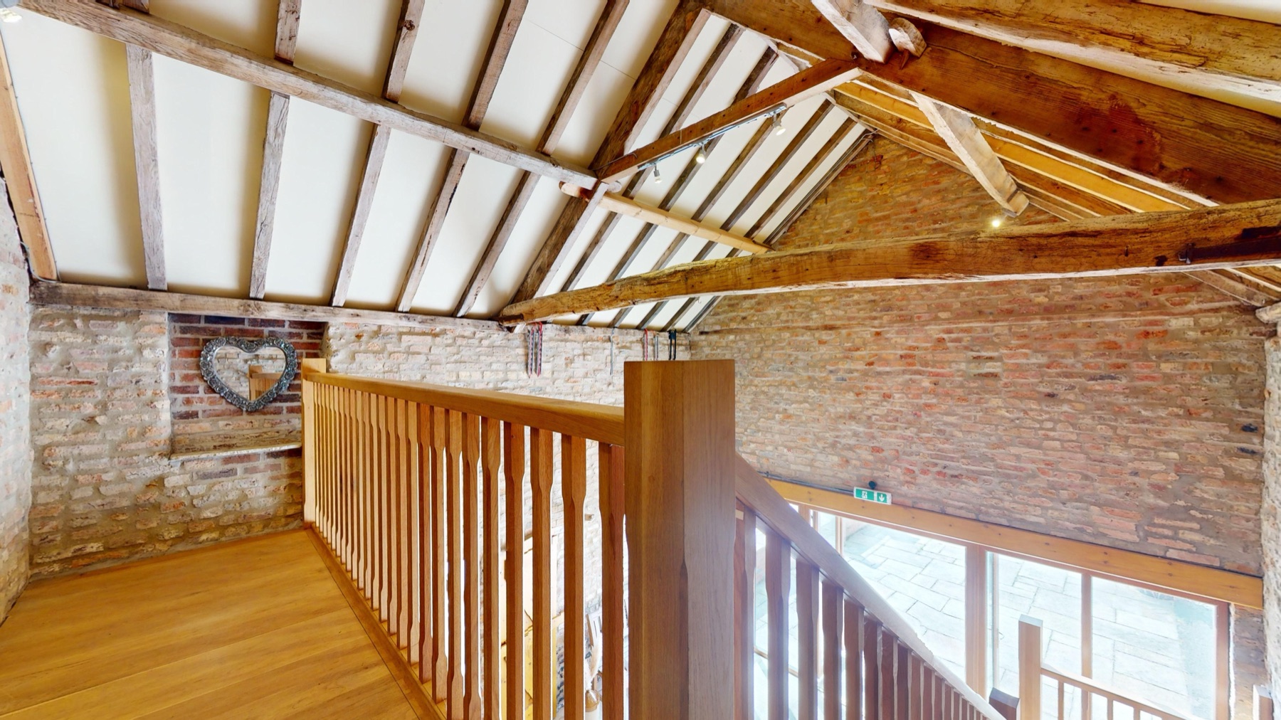 The Granary's galleried landing, with exposed brick and old timber beams
