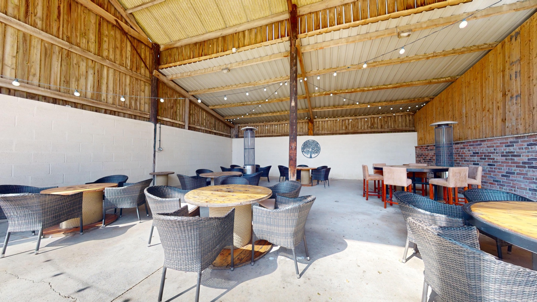 The covered Outside Barn seating area with festoon lights
